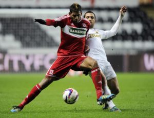 Swansea City's Schechter challenges Middlesbrough's Haroun during their English League Cup soccer match in Swansea